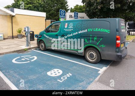 Une fourgonnette Gridserve EV Leasing se recharge à un point de recharge dans le parking de Blyth sevices sur l’autoroute A1M. Banque D'Images