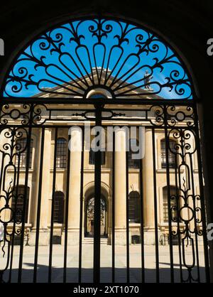 Le Clarendon Building est un bâtiment néoclassique du début du XVIIIe siècle de l'Université d'Oxford. Il se trouve dans Broad Street, à côté de la bibliothèque Bodleian et du théâtre Sheldonian et près du centre-ville. Ici, nous voyons sa façade encadrée par les portes fermées menant à la Bibliothèque Bodléienne. Banque D'Images