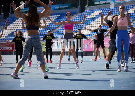 Groupe de personnes faisant de l'exercice de saut de jack lors d'un événement caritatif au stade de Kiev - 10 août, 2024 Banque D'Images