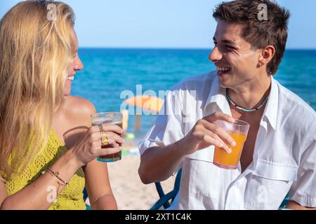 Heureux jeune couple en vacances, boire au restaurant Banque D'Images