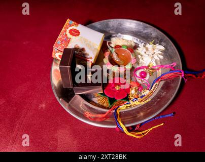 assiette isolée décorée de rakhi de fil sacré au festival hindu raksha bandhan à l'intérieur Banque D'Images
