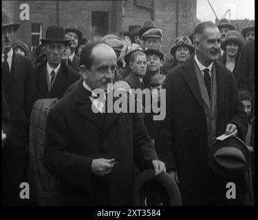 Sir James Barrie debout avec une foule de gens, 1921. De "Time to Remember - The Time When Little Happen", 1921 (bobine 2) ; événements de 1921 - traité irlandais, cascades folles et journaux au travail. Banque D'Images