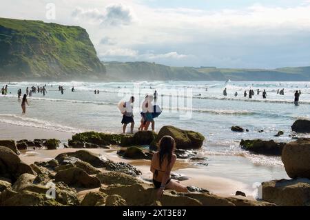 La plage de surfeurs parsemée de roches Playa de los Locos sur une chaude journée de juillet d'été sur la côte nord de l'Espagne Suances Cantabrie Espagne Europe Banque D'Images