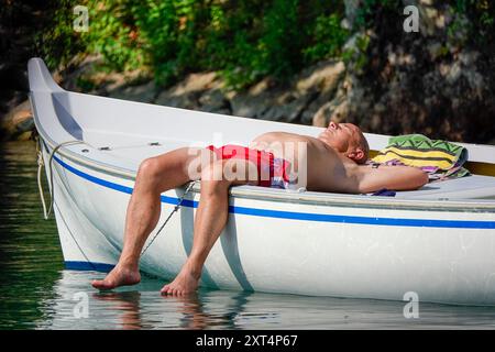 Fiume Mincio, Peschiera del Garda. 13 août 2024. Les conditions de canicule ont persisté dans une grande partie de l'Europe aujourd'hui, y compris le lac de Garde et ses environs dans le nord de l'Italie. Les températures diurnes devraient atteindre 37 degrés Celsius à l'ombre aujourd'hui. Les gens essayant de rester au frais à Peschiera del Garda, sur la rive sud du lac de Garde, dans le nord de l'Italie. Crédit : james jagger/Alamy Live News Banque D'Images