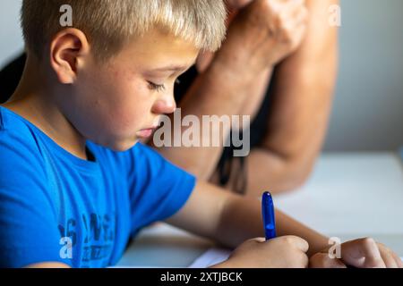 Un garçon portant un T-shirt bleu pleure à l'école Banque D'Images