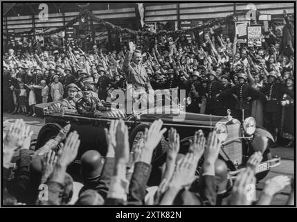 Années 1930 ADOLF HITLER AVEC DES FOULES EXTATIQUES AGITANT HEIL HITLER SALUE debout dans sa voiture Mercedes ouverte, Adolf Hitler salue une foule qui longe les rues de Hambourg. Sur la photo dans la voiture avec Hitler sont le Gauleiter de Hambourg, Karl Kauffmann, et le SS-Obergruppenfuhrer Joseph 'Sepp' Dietrich. 1934 17 août Hambourg, [Hansestadt] Allemagne Banque D'Images