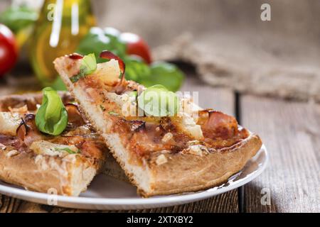 Faites des tranches de pizza hawaïenne sur vintage background Banque D'Images