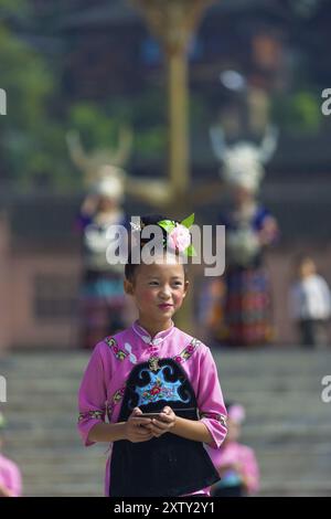 Xijiang, Chine, 15 septembre 2007 : une jeune fille de la minorité ethnique Miao vêtue de rose et de noir se produisant lors d'un festival local au traditionnel vill Miao Banque D'Images