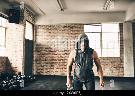 Homme, portrait et corde pour l'entraînement au gymnase pour la musculation avec force et détermination. Personne masculine, muscles et fort sur la formation, la forme physique et Banque D'Images