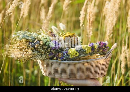 Jour de l'Assomption de Marie. Panier rustique de fleurs sauvages Banque D'Images