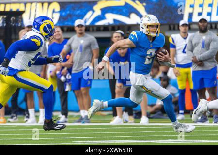 Los Angeles, Californie, États-Unis. 17 août 2024. Le quarterback Easton Stick #2 des Los Angeles Chargers court pour échapper à un tacle des Los Angeles Rams lors d'un match de pré-saison de football de la NFL au SoFi Stadium, samedi 17 août 2024, à Inglewood, Calif. (crédit image : © Ringo Chiu/ZUMA Press Wire) USAGE ÉDITORIAL SEULEMENT! Non destiné à UN USAGE commercial ! Banque D'Images