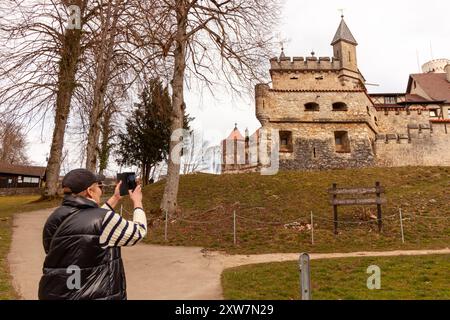 Femme mature prenant des photos des bâtiments du château de Lichtenstein, Baden Wuerttemberg, Allemagne Banque D'Images
