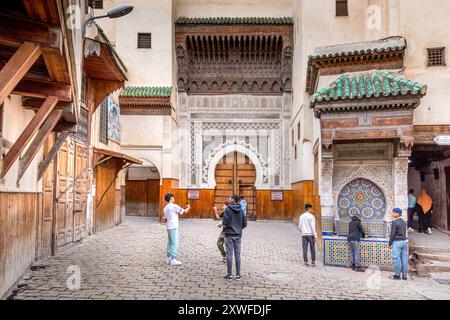 Fès, Maroc - 19 mars 2024 : L'entrée principale du Musée Nejjarine des Arts en bois et la fontaine Banque D'Images