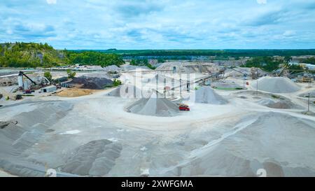 Vue aérienne de la carrière expansive avec piles de gravier et machines Banque D'Images
