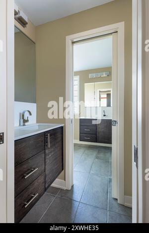 Lavabo dans le coin toilette et lavabo dans la salle de bains principale sont séparés par une porte coulissante Banque D'Images
