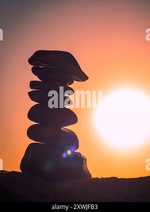 pyramide de pierres de galets au coucher du soleil Banque D'Images