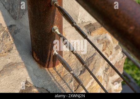 détail de la balustrade en corde en acier inoxydable offre la sécurité et un design moderne, tandis que la structure en acier corten assure la résistance aux agents atmosphériques. Banque D'Images