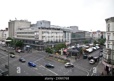 Une scène vibrante de l'emblématique grand magasin Karstadt sur Hermannplatz à Berlin-Neukölln en 2010. L'image capture l'environnement dynamique de la ville, mettant en valeur un mélange d'architecture traditionnelle et de vie urbaine moderne. Banque D'Images