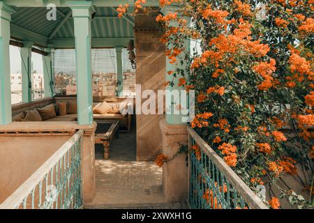 Charmant Riad Rooftop terrasse avec fleurs de Bougainvilliers, style architectural de luxe rustique, ombres douces, coin salon extérieur serein et enchanteur, Banque D'Images