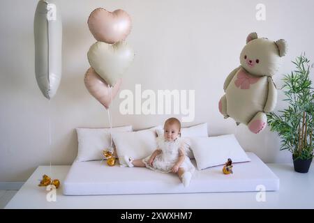 une séance photo sur le premier anniversaire d'une petite fille, dans des couleurs pastel, minimalisme Banque D'Images