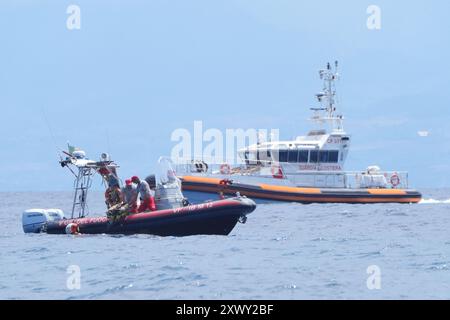 Une équipe de plongée des pompiers italiens récupère son équipement dans la mer au large de la côte de Porticello, en Sicile, le troisième jour de la recherche de six touristes portés disparus après que le yacht de luxe Bayesian a coulé dans une tempête lundi alors qu'il était amarré à environ 800 mètres au large de la côte. Les garde-côtes italiens n'ont pas exclu la possibilité que les personnes disparues soient encore en vie, les experts spéculant que des poches d'air auraient pu se former lorsque le yacht a coulé. Date de la photo : mercredi 21 août 2024. Banque D'Images