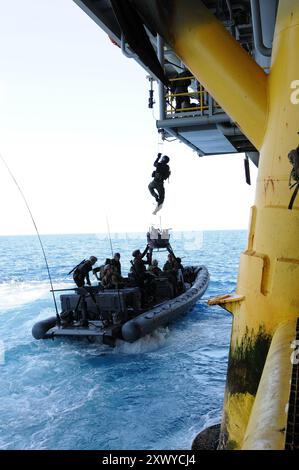 Le 28 juillet 2011, les US Navy SEAL s'entraînent avec l'équipe spéciale des bateaux 12 sur les techniques appropriées pour monter à bord des plates-formes gazières et pétrolières à partir d'un navire en mouvement près de long Beach, Calif. Les SEAL effectuent ces exercices pour perfectionner leurs diverses compétences en opérations maritimes. Photo du Département de la Défense par le maître de 3e classe Adam Henderson, US Navy. Banque D'Images