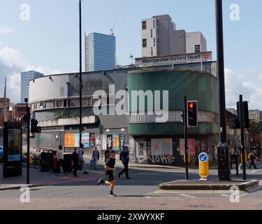 Manchester Oxford Road Railway Station comme un homme court dans une rue à l'extérieur. Manchester, Angleterre. 20 août 2024 Banque D'Images
