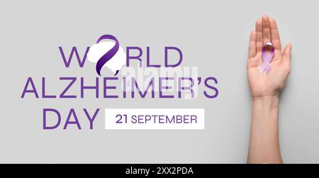Bannière pour la Journée mondiale de la maladie d'Alzheimer avec ruban de sensibilisation tenant la main Banque D'Images