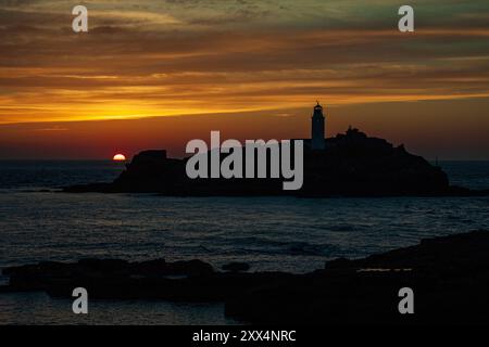 Coucher de soleil sur le phare de Godrevy vu du sommet de la falaise près de la côte de Gwithian, Cornwall, Royaume-Uni Banque D'Images