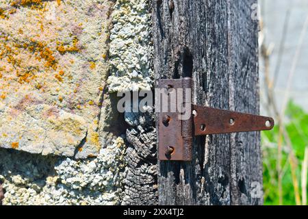 Closeup of an old metal door hinge on an abandoned rock building, probably a service station at one time, located on Old Route 66, near Spencer, MO. Stock Photo