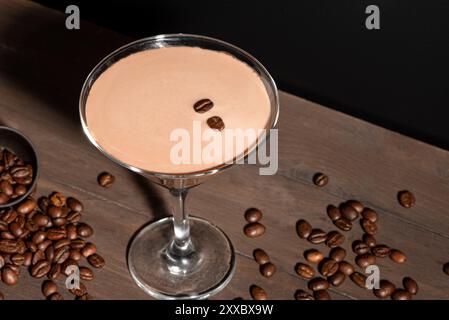 Cocktail espresso Martini avec grains de café sur fond sombre, vue de dessus, espace copie. Boisson de liqueur de café. Banque D'Images