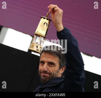 Stoke Mandeville, Britain. 24th Aug, 2024. Tony Estanguet, president of the Paris 2024 Olympics and Paralympics Organizing Committee, holds the flame lantern during the Paralympic Torch-Lighting Ceremony for the Paris 2024 Paralympic Games at Stoke Mandeville, Britain, on August 24, 2024. Credit: Li Ying/Xinhua/Alamy Live News Stock Photo