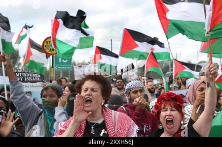 Blackburn, England, UK. 24th Aug, 2024. Protesters shout and chant during the demonstration outside the main gates of The BAE Systems facility. Protesters accuse BAE Systems of being complicit in the Gaza genocide by producing parts for the F-35 fighter jets at their Samlesbury facility, used in the air assault of Gaza and Yemen. Since 07/10/24 over 5000 airstrikes have been directed at Gaza leaving thousands of civilians dead, including 16,500 children. Credit: ZUMA Press, Inc./Alamy Live News Stock Photo