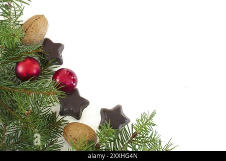 Fond de coin de Noël et du nouvel an avec branches, boules, noix et chocolat isolé sur blanc Banque D'Images