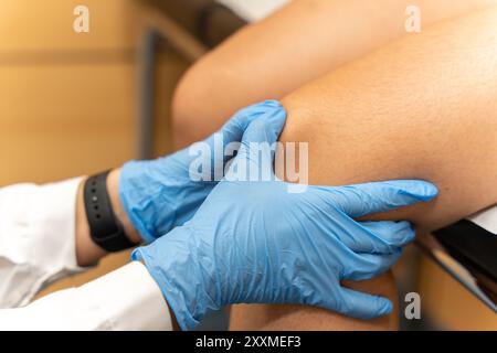 Examen complet du genou d'un patient en milieu clinique hospitalier, axé sur le traitement orthopédique et le diagnostic Banque D'Images