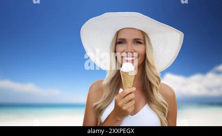 Une femme blonde aime manger une glace dans un cône Banque D'Images