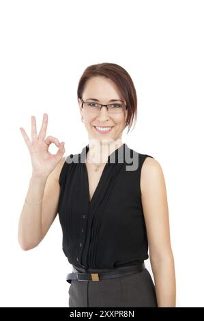 Une belle femme d'affaires souriante montre OK isolé sur fond blanc Banque D'Images