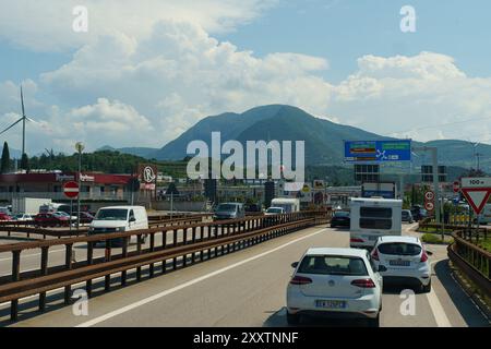 Progni, Italie - 8 juin 2023 : les véhicules empruntent une autoroute animée flanquée de montagnes, avec un ciel dégagé laissant entrevoir une agréable conduite. Banque D'Images