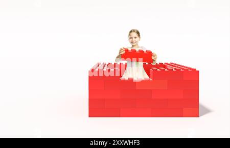 Souriant jeune fille bâtissant des blocs de jouet rouges sur fond blanc Banque D'Images