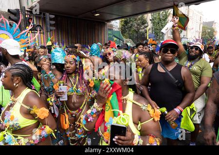 Les gens pendant la célébration du carnaval de Notting Hill dans l'ouest de Londres qui a lieu pendant le week-end de vacances bancaires d'été. Date de la photo : lundi 26 août 2024. Banque D'Images