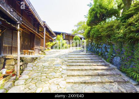 Maisons traditionnelles en bois de style japonais sur un chemin en pierre restaurée à Tsumago village sur la route Nakasendo historique au Japon. L'horizontale Banque D'Images