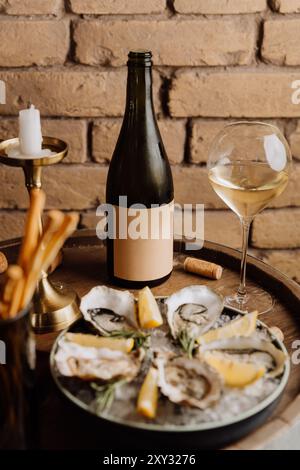 Huîtres élégantes sur glace avec citron et vin blanc, parfaites pour les repas gastronomiques et les occasions spéciales Banque D'Images