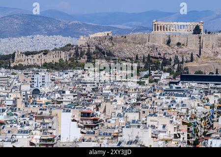 Athènes, Grèce. 26 août 2024. Le paysage urbain du centre de la capitale grecque peut être vu avec Acropole en arrière-plan. Le pays est confronté à une pénurie croissante de logements qui est devenue un grave problème social le rendant extrêmement inabordable pour les ménages ordinaires. Alors que le gouvernement grec blâme le programme Golden Visa et a des plans pour resserrer les règles, beaucoup de gens blâment également les locations à court terme comme Airbnb. Crédit : Dimitris Aspiotis/Alamy Banque D'Images