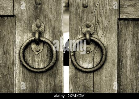 Ancienne porte en bois avec deux anneaux de frappe de porte en gros plan Banque D'Images