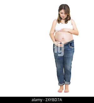 Young pretty smiling pregnant woman on white background in studio Stock Photo