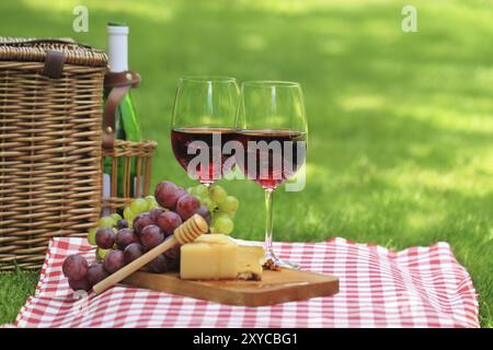 Diverses sortes de fromage, raisins et deux verres de vin rouge Banque D'Images