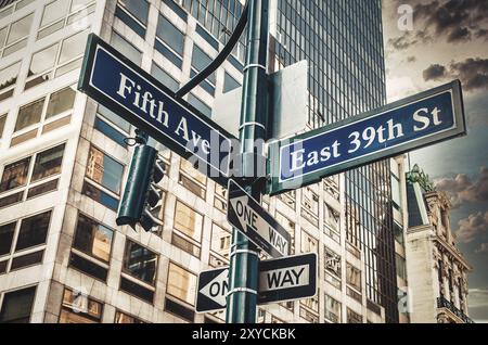 Fifth Ave 5th Ave, New York City Sign, vue de bas angle avec coucher de soleil et gratte-ciel en arrière-plan, usa Banque D'Images