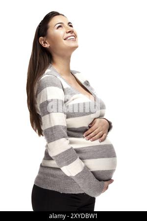 Heureuse jeune femme enceinte touchant son ventre Banque D'Images