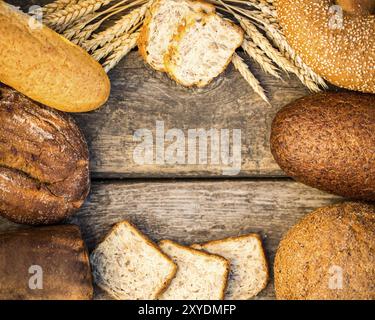 Pain et blé maison sur la table en bois dans le champ d'automne Banque D'Images