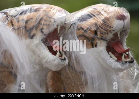 Tigres en peluche enveloppés de papier aluminium dans un marché aux puces Banque D'Images